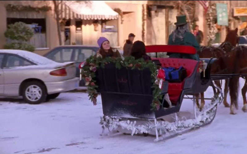 1991 Saturn SC parked while carriage drives by