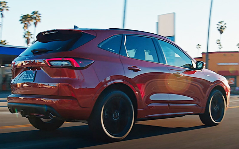 A red 2026 Ford Escape on a city roadway