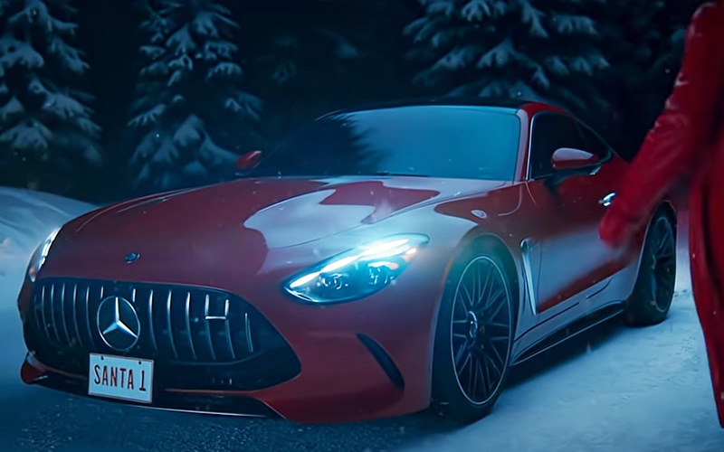 A red Mercedes-Benz parked in the snow