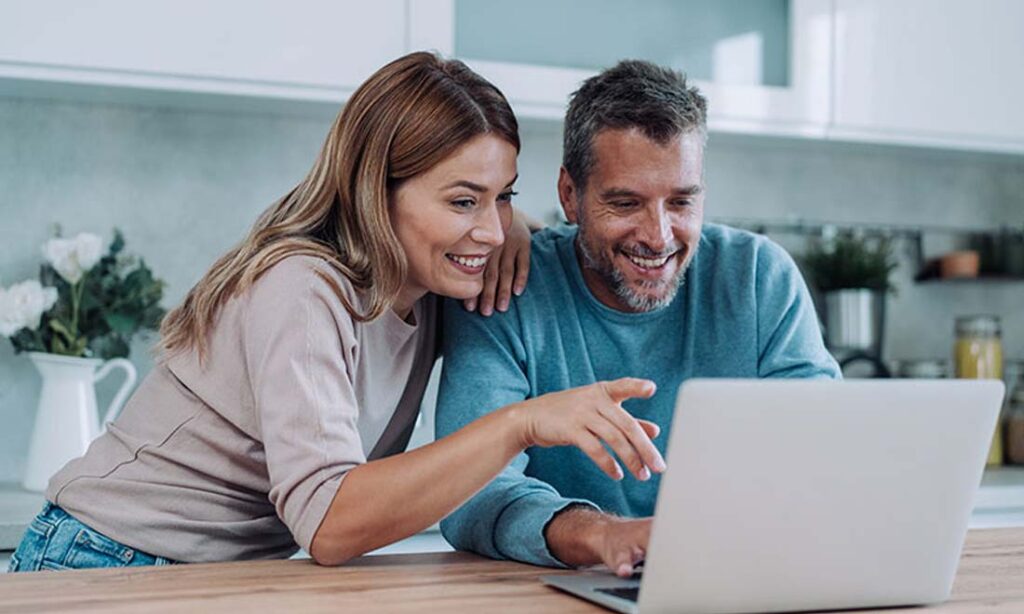 A couple on a laptop buying a car