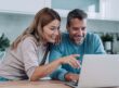 A couple on a laptop buying a car
