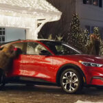 The Griswolds looking at a red Ford Mach-E