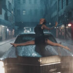 Taylor Swift in the splits on the hood of a 1967 Cadillac Fleetwood 60 Special