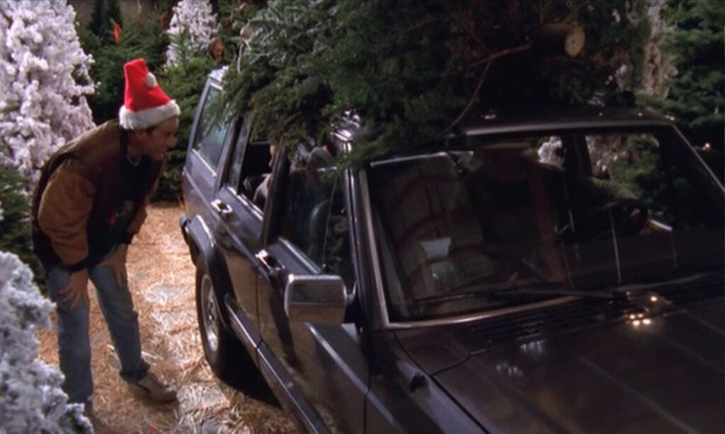 1990 Jeep Cherokee with Christmas tree on top