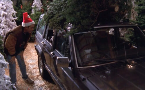 1990 Jeep Cherokee with Christmas tree on top