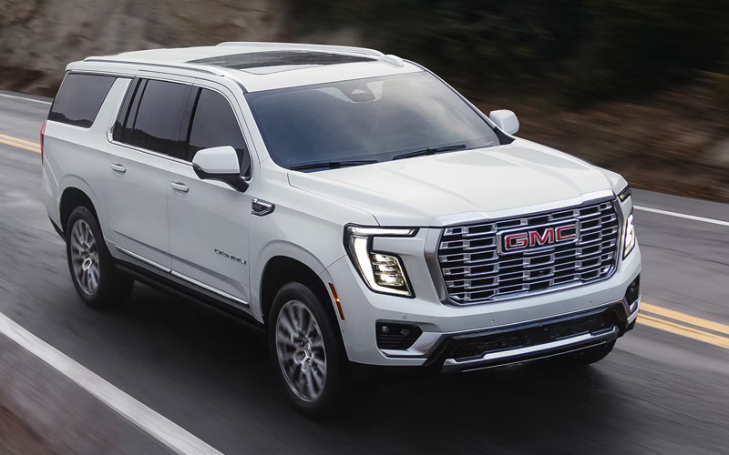 A white 2026 GMC Yukon on a highway