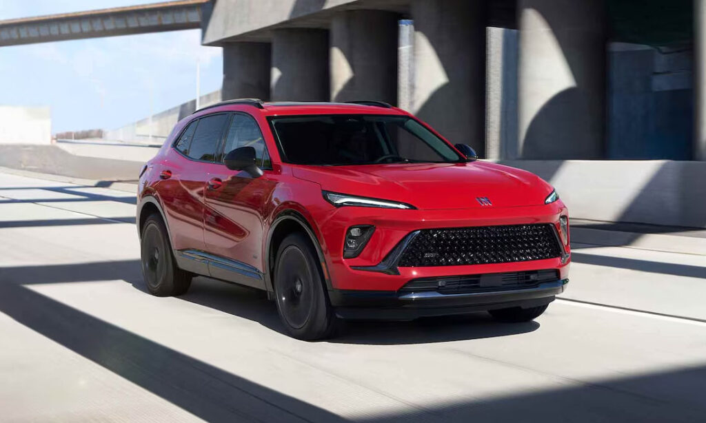 Red 2026 Buick Envision driving on the road