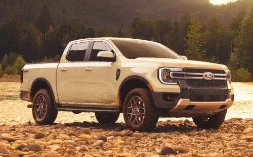 A white 2026 Ford Ranger parked on some rocks near a river