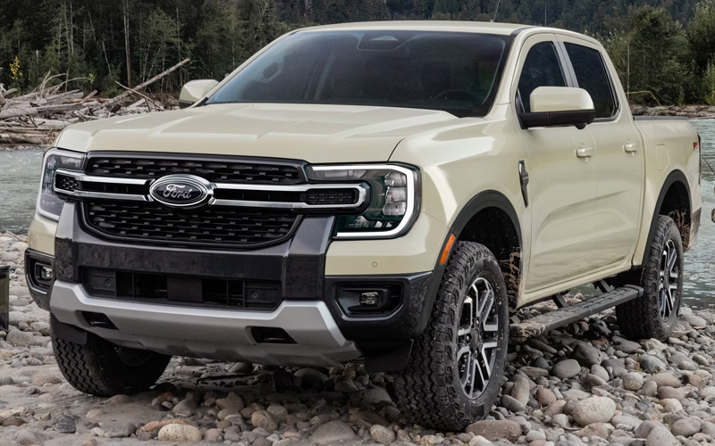 A white 2026 Ford Ranger parked on some rocks near a river