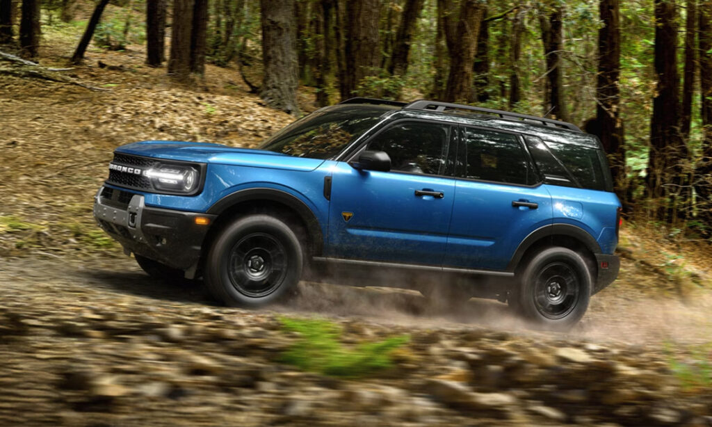 Blue 2026 Ford Bronco Sport driving through a wooded area
