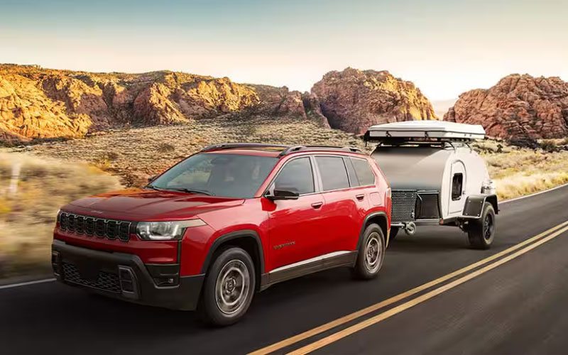 2026_Jeep_Cherokee_Towing Red 2026 Jeep Cherokee towing a small camper