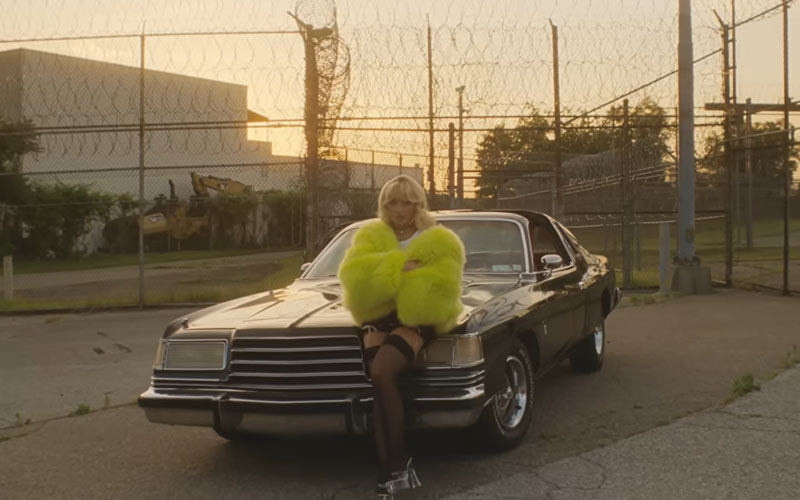 SC_1979_Dodge_Magnum_XE Sabrina Carpenter leaning against the hood of a 1979 Dodge Magnum XE